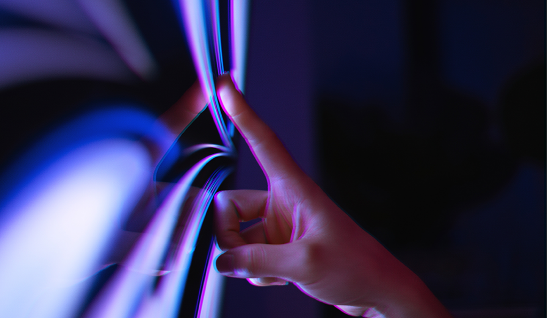 A person’s hand making contact with a digital touchscreen, highlighting the interaction between human and technology.