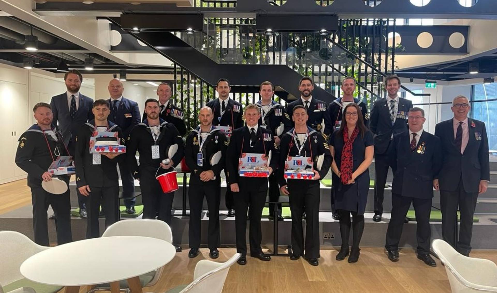 Several serving and veteran services personnel in suits and ties gathered together, showing solidarity whilst showcasing their various awards.