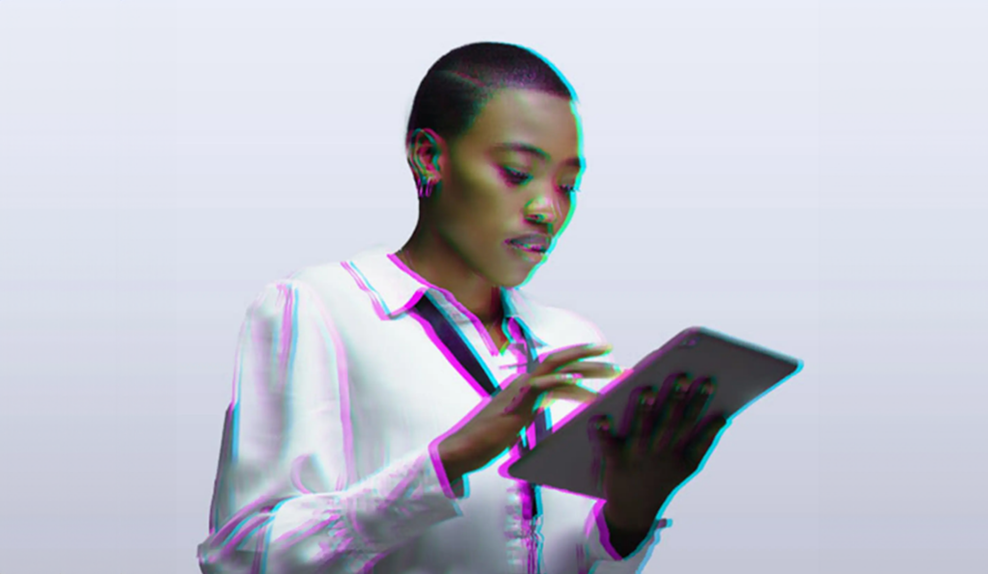 A woman utilizing a tablet computer, demonstrating concentration and engagement with the device.