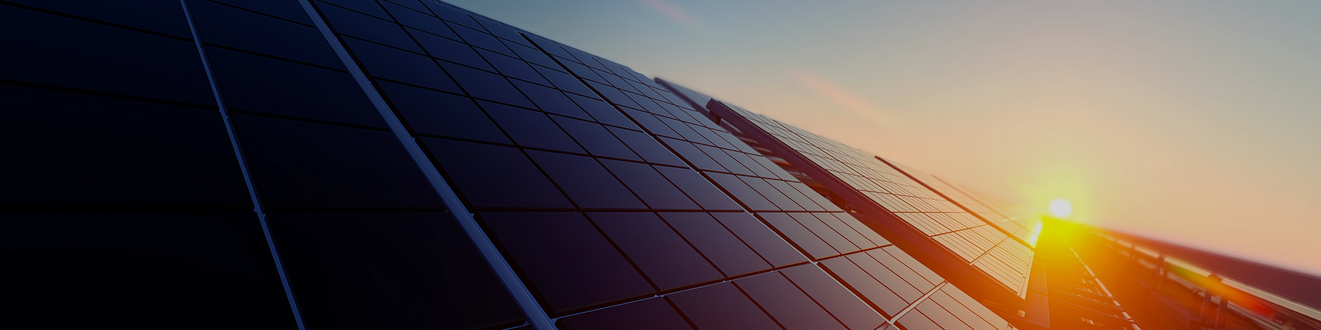 A rooftop adorned with solar panels, set against a vibrant sunset sky, highlighting sustainable energy solutions.