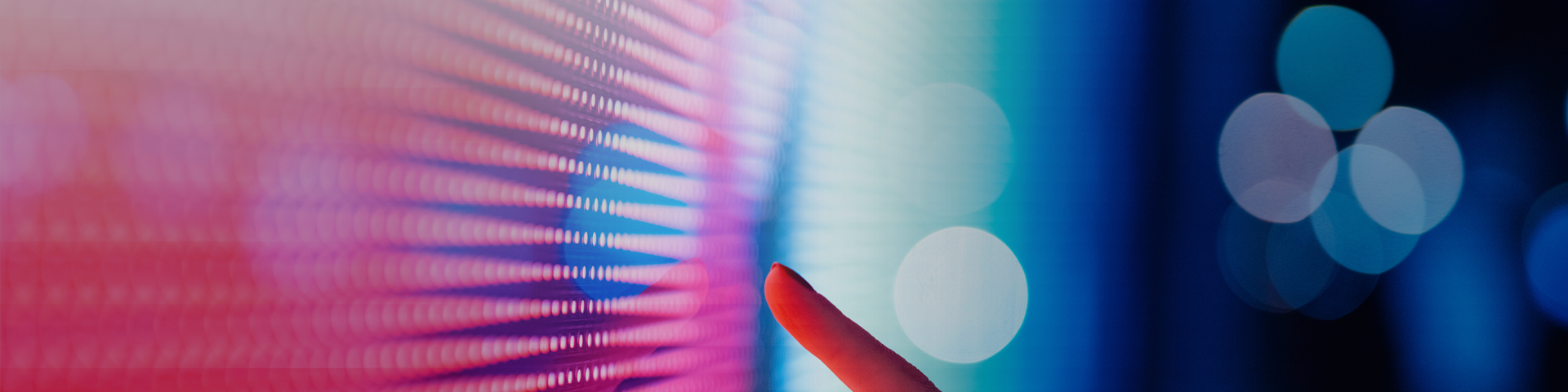 A close-up of a finger making contact with a bright, colorful touchscreen, illustrating user engagement with the device.