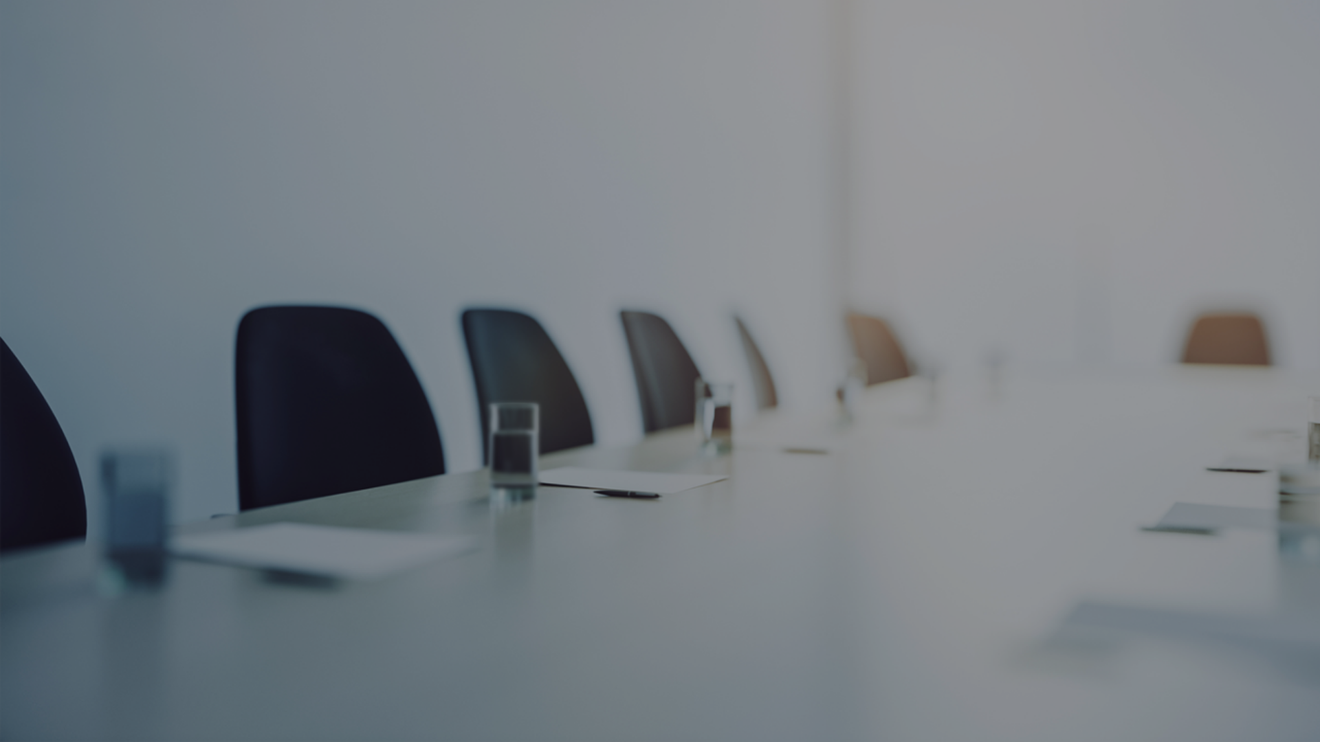 A well-arranged conference table with chairs and glasses of water, set for discussions and collaboration.