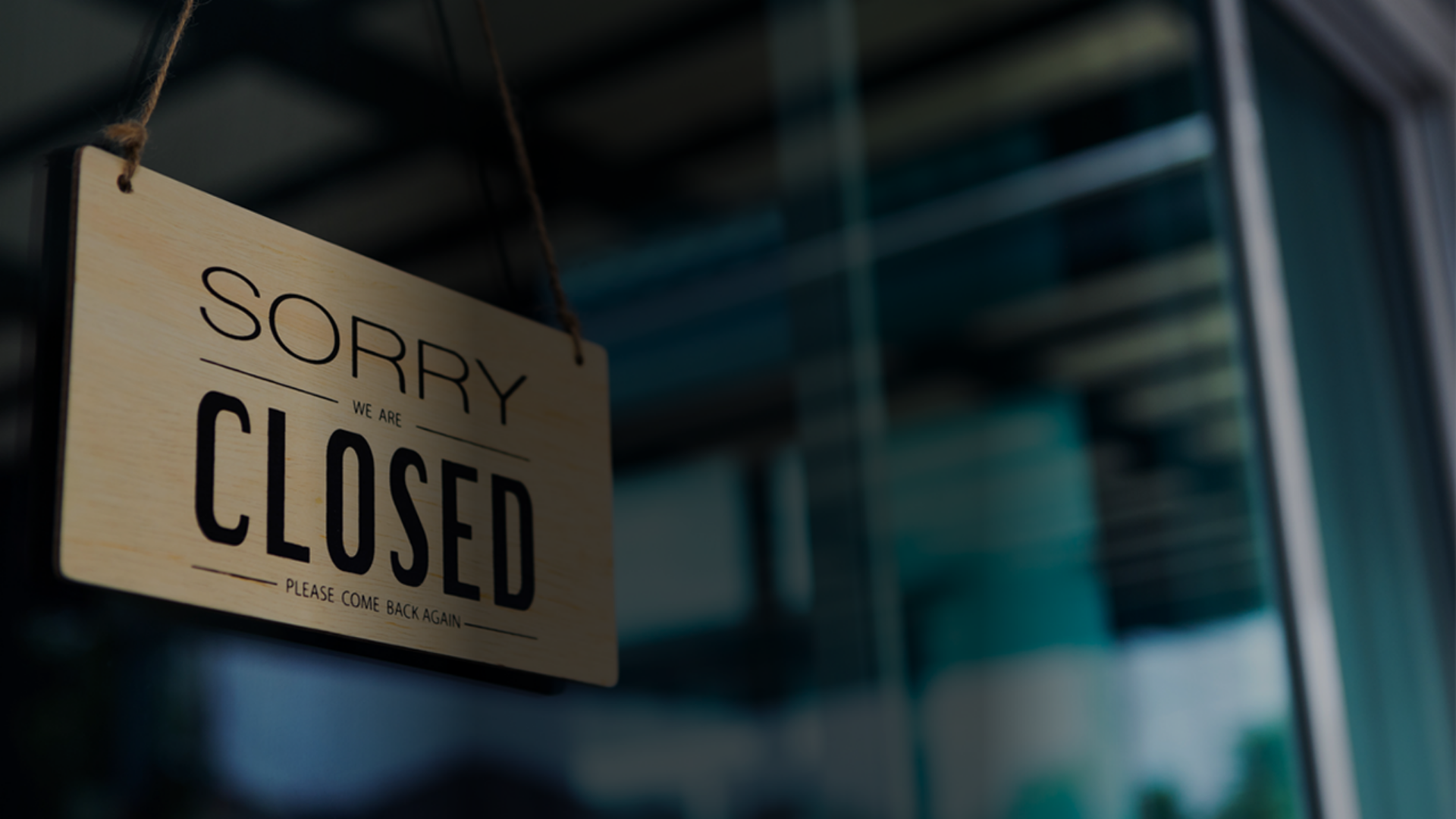 A "Sorry, Closed" sign is prominently displayed on a door, indicating that the establishment is not open for business.