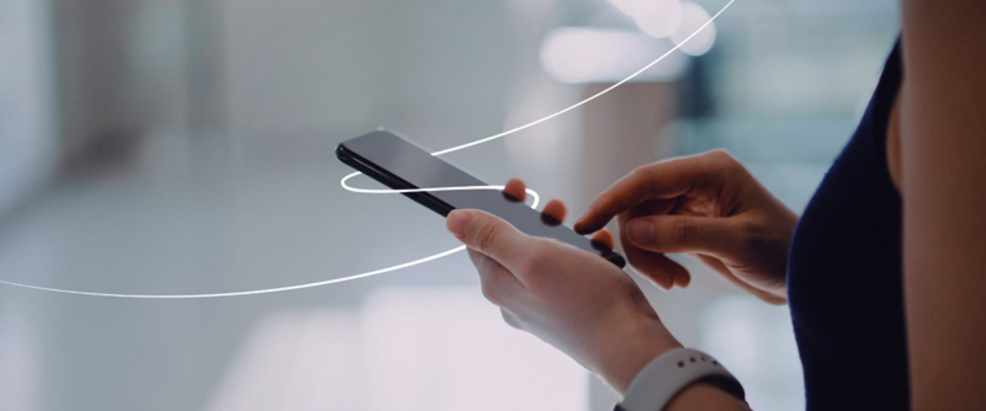 A woman grips a smartphone, with a circular border around it, highlighting the technology in her hand.