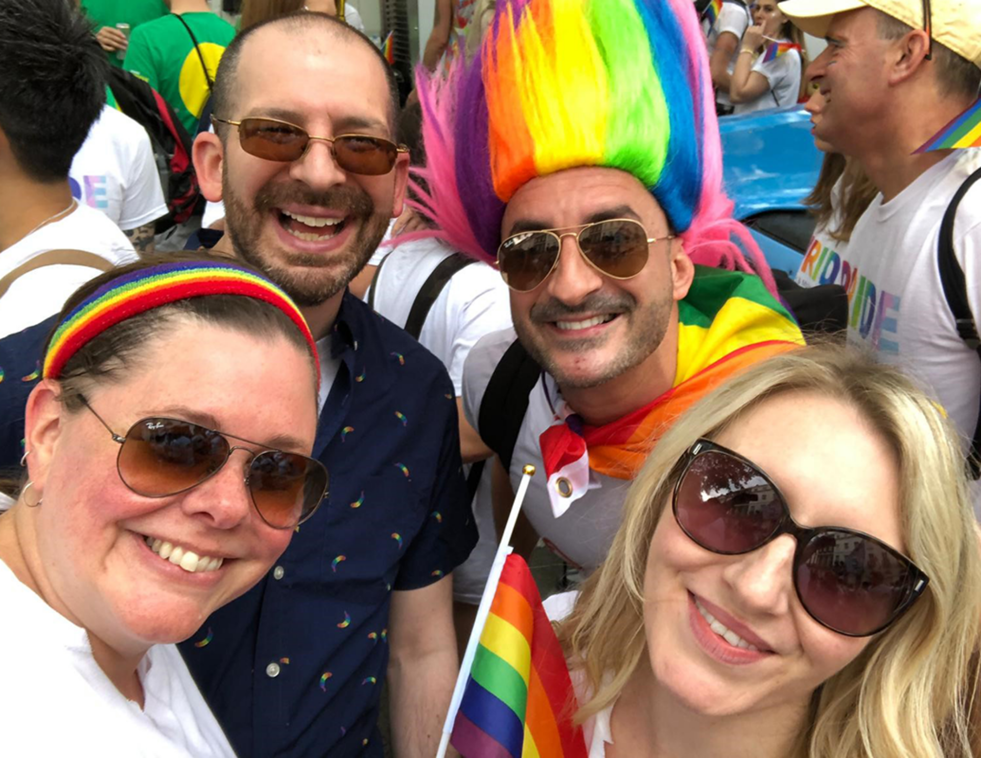 A colorful pride parade scene with a group of people expressing solidarity and pride in their identities.