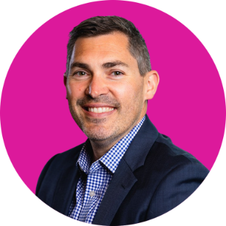 Headshot of Brandon Joyce with pink circle background
