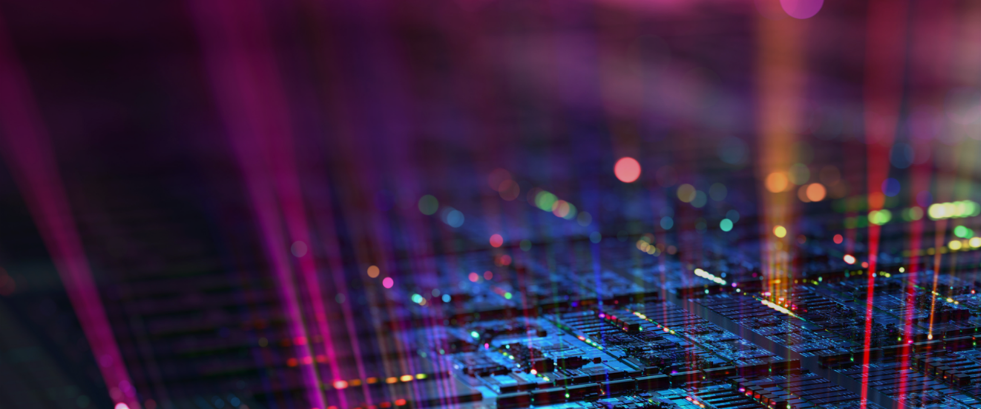 A close-up of a computer chip illuminated by vibrant, colorful lights, showcasing intricate circuitry and design.