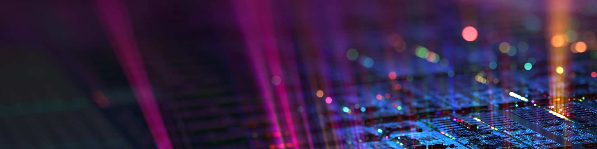 A close-up of a computer chip illuminated by vibrant, colorful lights, showcasing intricate circuitry and design.