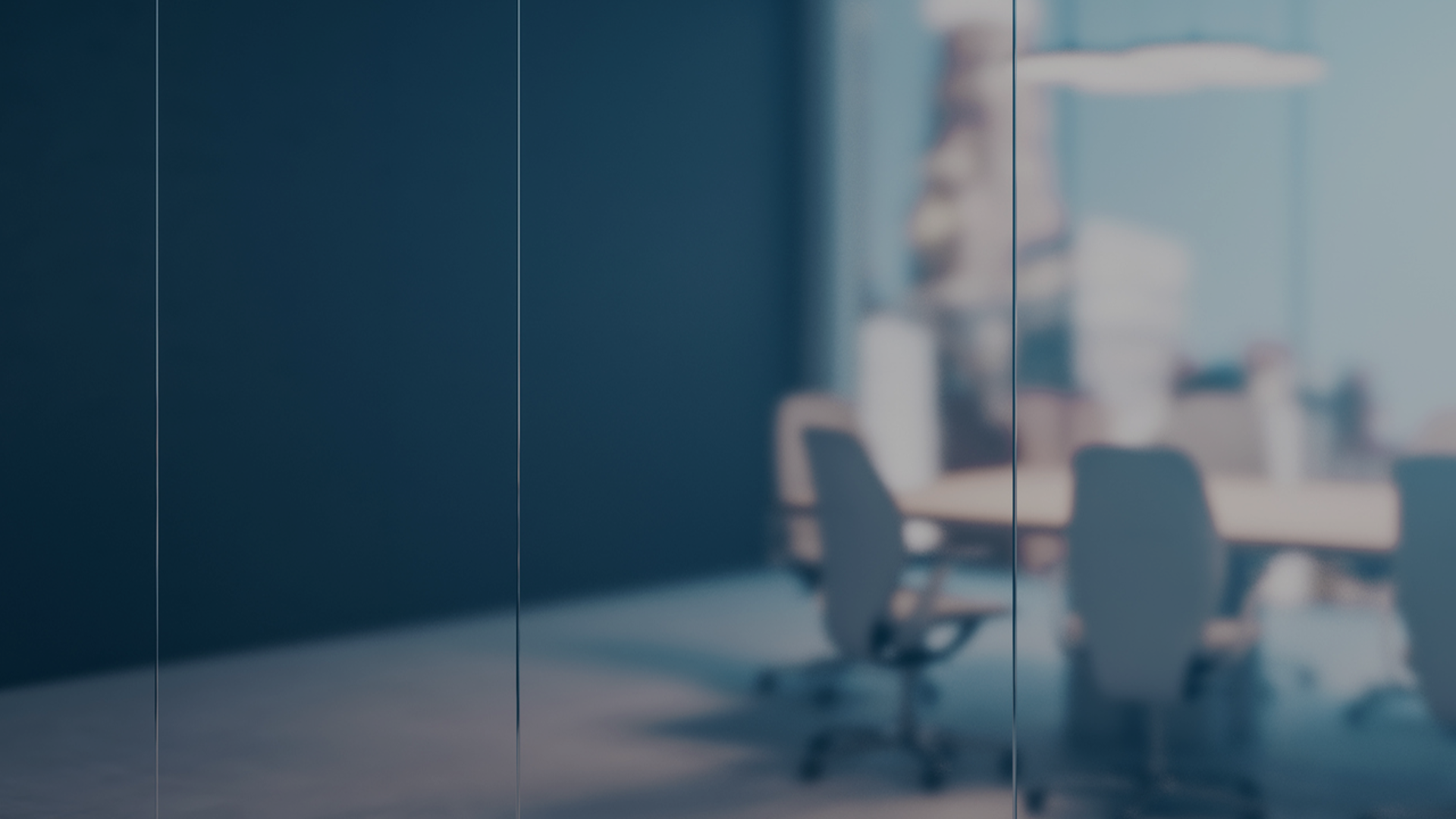 Interior view of a conference room with a central table and multiple chairs arranged for collaborative sessions.