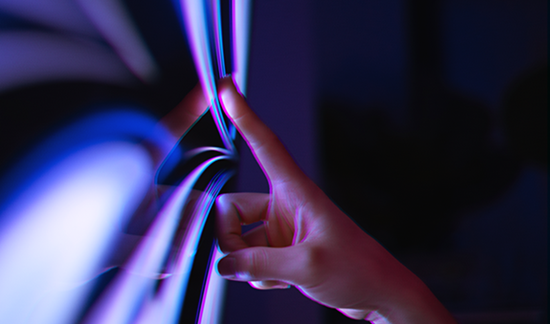 A person’s hand making contact with a digital touchscreen, highlighting the interaction between human and technology.