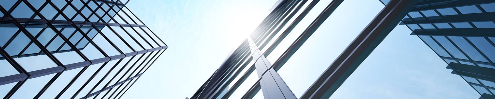 A skyline featuring tall buildings adorned with numerous windows reflecting the surrounding environment.